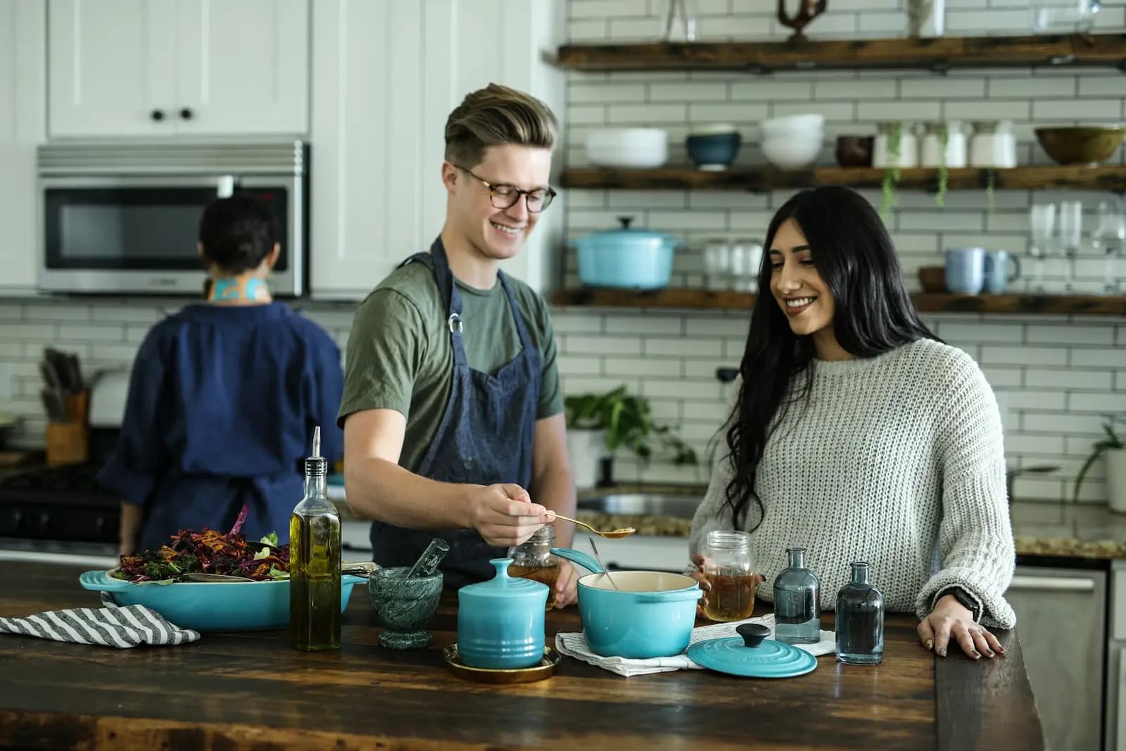 Chef preparing dishes alongside guests